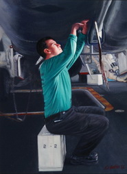 Green Shirt Working on the Underside of a F-18