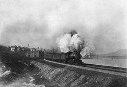 Old steamer by the Beaver River with Fetterman Bridge in background. 1925