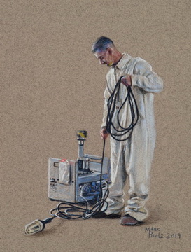 Untitled (marine in White Coveralls holding electrical cord next to equipment)