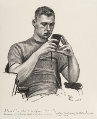 A Marine of 1/24 checks his smartphone