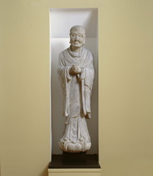 Standing monk or lohan with hands clasped 
