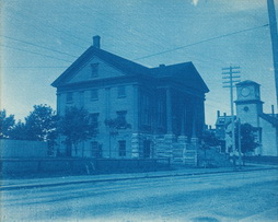 Greek Revival Building with Ionic Portico and Frame Church In Right Middle Ground