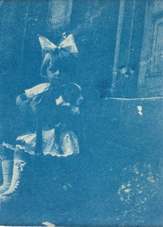 Seated Girl Holding Boston Terrier
